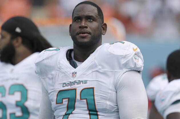 Miami Dolphins tackle Branden Albert (71) looks up from the sideline during the second half of an NFL football game against the New England Patriots, Sunday, Sept. 7, 2014 in Miami Gardens, Fla. The Dolphins defeated the Patriots 33-20. (AP Photo/Wilfredo Lee)