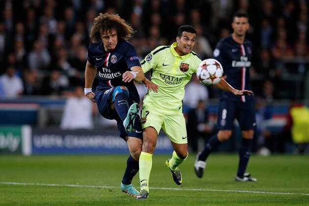 PARIS, FRANCE - SEPTEMBER 30:  David Luiz of PSG clears the ball away from Pedro of Barcelona during the Group F UEFA Champions League match between Paris Saint-Germain v FC Barcelona held at Parc des Princes on September 30, 2014 in Paris, France.  (Photo by Dean Mouhtaropoulos/Getty Images)