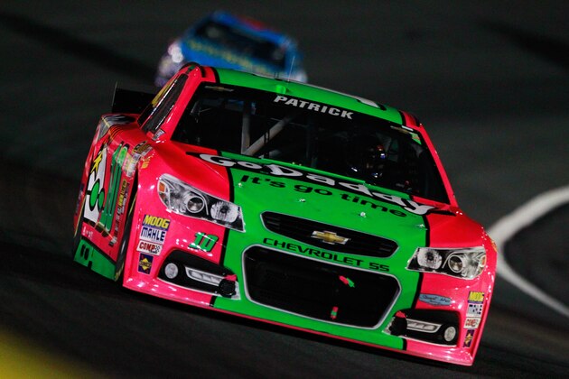 CHARLOTTE, NC - OCTOBER 11:  Danica Patrick, driver of the #10 GoDaddy Breast Cancer Awareness Chevrolet, leads Aric Almirola, driver of the #43 Smithfield / Waffle House Ford, during the NASCAR Sprint Cup Series Bank of America 500 at Charlotte Motor Speedway on October 11, 2014 in Charlotte, North Carolina.  (Photo by Brian Lawdermilk/Getty Images)
