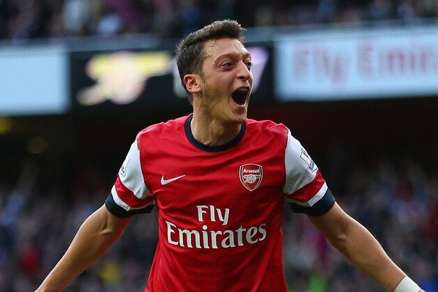 LONDON, ENGLAND - OCTOBER 19:  Mesut Oezil of Arsenal celebrates as he scores their second goal during the Barclays Premier League match between Arsenal and Norwich City at the Emirates Stadium on October 19, 2013 in London, England.  (Photo by Paul Gilham/Getty Images)