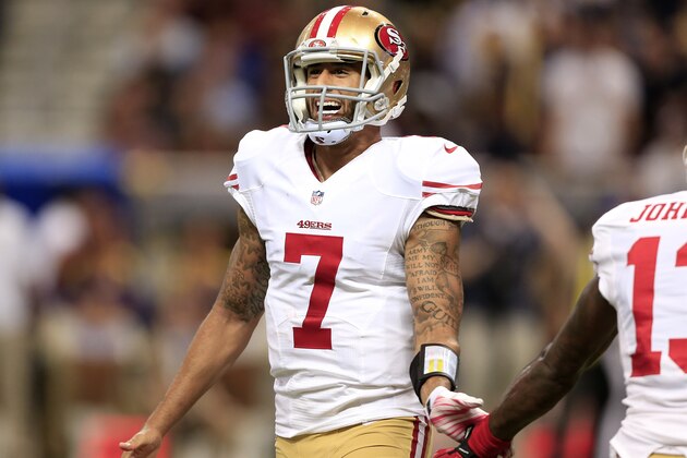 San Francisco 49ers quarterback Colin Kaepernick (7) slaps hands with Steve Johnson (13) after Kaepernick threw a touchdown pass against the St. Louis Rams in the third quarter of an NFL football game Monday, Oct. 13, 2014, in St Louis. (AP Photo/Billy Hurst)