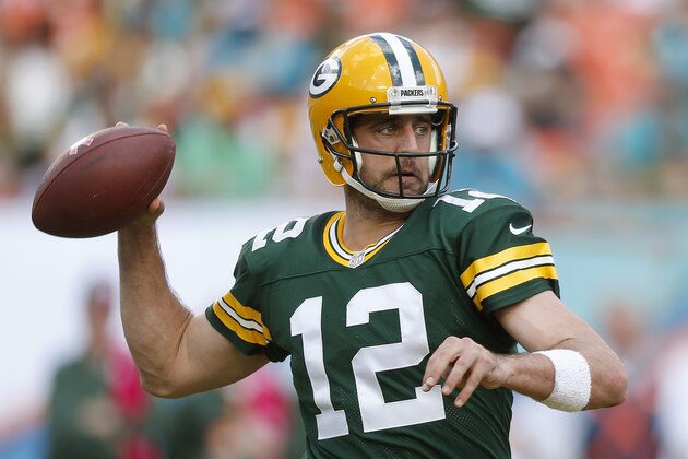MIAMI GARDENS, FL - OCTOBER 12:  Quarterback Aaron Rodgers #12 of the Green Bay Packers throws in the second quarter during a game against the Miami Dolphins at Sun Life Stadium on October 12, 2014 in Miami Gardens, Florida.  (Photo by Joel Auerbach/Getty Images)
