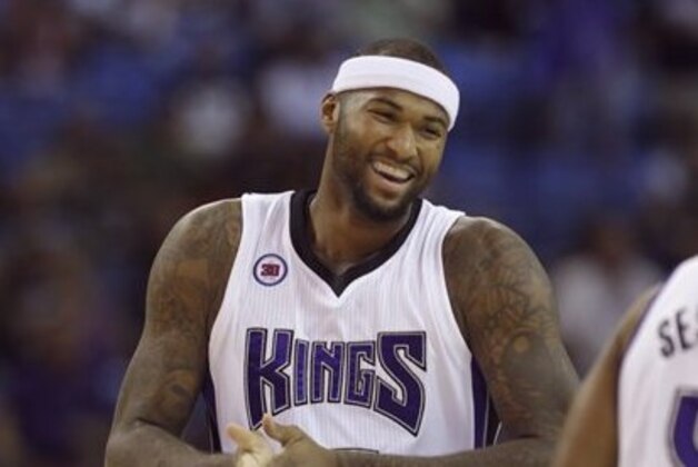 Sacramento Kings center DeMarcus Cousins laughs as he walks downcourt during an NBA preseason game against the Toronto Raptors in Sacramento, Calif., Tuesday, Oct. 7, 2014.  The Kings won 113-106. (AP Photo/Rich Pedroncelli)
