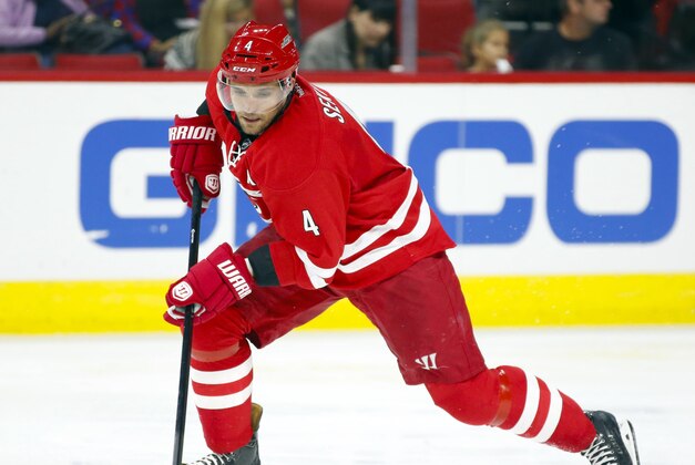 Oct 3, 2014; Raleigh, NC, USA; Carolina Hurricanes defensemen Andrej Sekera (4) carries the puck against the Buffalo Sabres during the 2nd period at PNC Arena. The Carolina Hurricanes defeated the Buffalo Sabres 5-1. Mandatory Credit: James Guillory-USA TODAY Sports