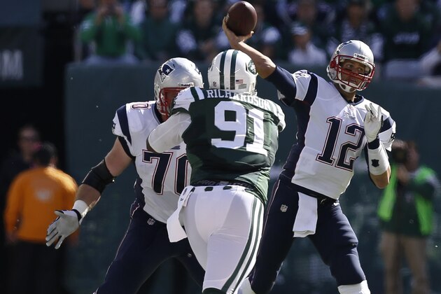 EAST RUTHERFORD, NJ - OCTOBER 20:   Tom Brady #12 of the New England Patriots passes against the New York Jets during their game at MetLife Stadium on October 20, 2013 in East Rutherford, New Jersey.  (Photo by Jeff Zelevansky/Getty Images)