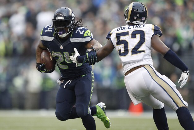Dec 29, 2013; Seattle, WA, USA; Seattle Seahawks running back Marshawn Lynch (24) carries the ball against the St. Louis Rams during the third quarter at CenturyLink Field. Mandatory Credit: Joe Nicholson-USA TODAY Sports