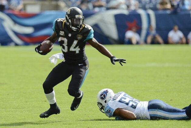 Jacksonville Jaguars running back Storm Johnson (34) carries the ball against the Tennessee Titans in the third quarter of an NFL football game Sunday, Oct. 12, 2014, in Nashville, Tenn. (AP Photo/Mark Zaleski)