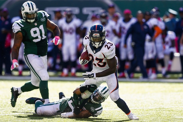 EAST RUTHERFORD, NJ - OCTOBER 12: Sheldon Richardson #91 and Dawan Landry #26 of the New York Jets attempt to tackle Ronnie Hillman #23 of the Denver Broncos in the third quarter at MetLife Stadium on October 12, 2014 in East Rutherford, New Jersey.  (Photo by Jeff Zelevansky/Getty Images)