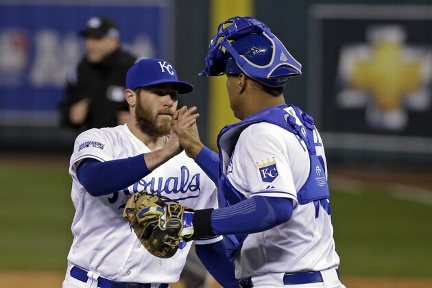 Kansas City Royals relief pitcher Greg Holland is congratulated by Salvador Perez following Game 3 of the American League baseball championship series Tuesday, Oct. 14, 2014, in Kansas City, Mo. The Royals won 2-1 and lead the series 3-0. (AP Photo/Matt Slocum )