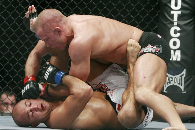 BJ Penn, bottom, takes a right from Georges St. Pierre during their UFC welterweight mixed martial art title bout Saturday, Jan. 31, 2009 in Las Vegas. St. Pierre won by TKO. (AP Photo/Eric Jamison)