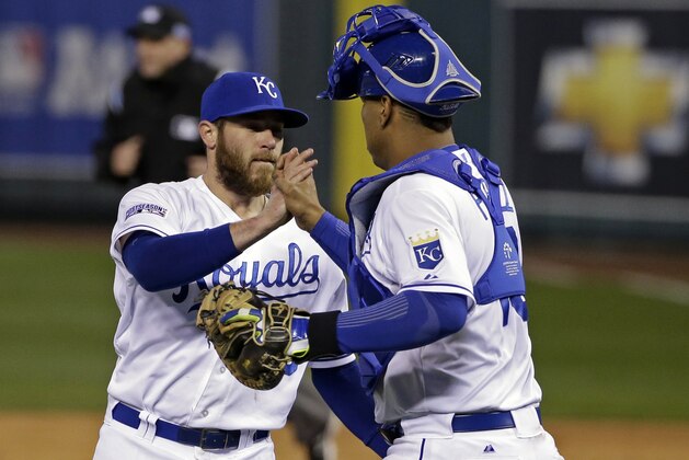 Kansas City Royals relief pitcher Greg Holland is congratulated by Salvador Perez following Game 3 of the American League baseball championship series Tuesday, Oct. 14, 2014, in Kansas City, Mo. The Royals won 2-1 and lead the series 3-0. (AP Photo/Matt Slocum )