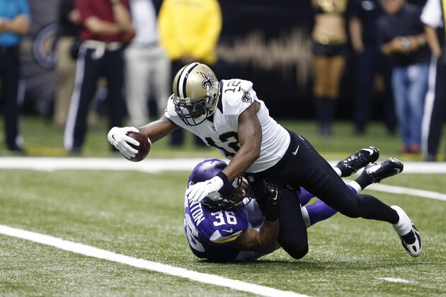 New Orleans Saints wide receiver Marques Colston (12) scores on a touchdown reception over Minnesota Vikings strong safety Robert Blanton (36) in the second half of an NFL football game in New Orleans, Sunday, Sept. 21, 2014. (AP Photo/Rogelio Solis)