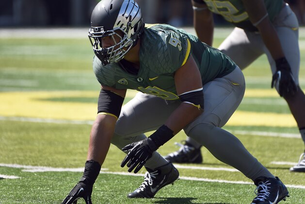 Oregon defensive lineman Arik Armstead (9) gets set at the line of scrimmage during the first quarter of the college football game against the Wyoming at Autzen Stadium on Saturday, Sept. 13, 2014 in Eugene, Ore. (AP Photo/Steve Dykes)