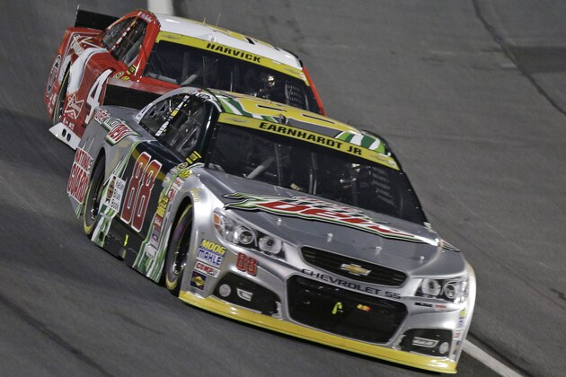 Dale Earnhardt Jr (88) leads Kevin Harvick (4) during the NASCAR Sprint Cup series Bank of America 500 auto race at Charlotte Motor Speedway in Concord, N.C., Saturday, Oct. 11, 2014. (AP Photo/Chuck Burton)
