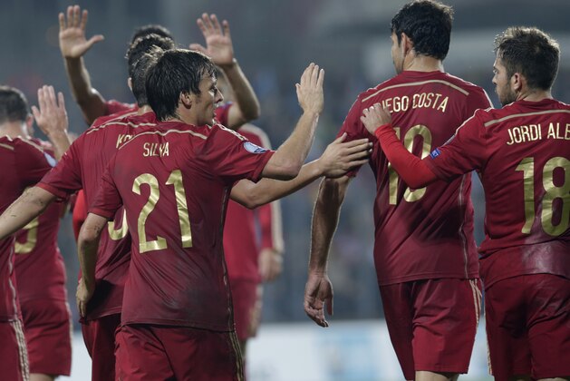 Spain's David Jimenez Silva, left, is congratulated by team members after he scored during the Euro 2016 qualifying match in group C between Luxembourg and Spain at the Josy Barthel stadium, in Luxembourg City, Luxembourg, Sunday, Oct. 12, 2014. (AP Photo/Yves Logghe)