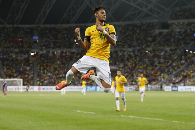 Brazil's Neymar celebrates after scoring the forth goal during an international friendly soccer match in Singapore, Tuesday, Oct. 14, 2014. (AP Photo/Wong Maye-E)