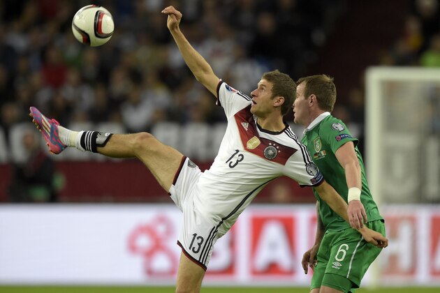 Germany’s Thomas Mueller and Ireland’s Glenn Whelan, from left, challenge for the ball during a Euro 2016 group D qualifying soccer match between Germany and Ireland in Gelsenkirchen, Germany, Tuesday, Oct. 14, 2014. (AP Photo/Martin Meissner)