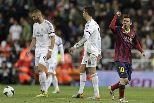 FC Barcelona's Lionel Messi from Argentina, right celebrates next to Real Madrid's Cristiano Ronaldo, centre and Karim Benzema, left after scoring his team's 2nd goal during a Spanish La Liga soccer match at the Santiago Bernabeu stadium in Madrid, Sunday March 23, 2014. (AP Photo/Paul White)