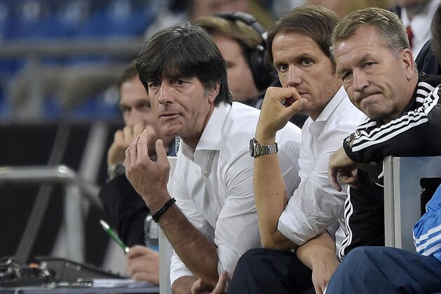 Germany’s head coach Joachim Loew, left, watches from the bench during a Euro 2016 group D qualifying soccer match between Germany and Ireland in Gelsenkirchen, Germany, Tuesday, Oct. 14, 2014. (AP Photo/Martin Meissner)