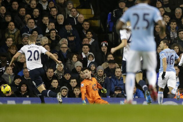 Manchester City's Sergio Aguero, right, scores during the English Premier League soccer match between Tottenham Hotspur and Manchester City at White Hart Lane stadium in London, Wednesday, Jan. 29, 2014.  (AP Photo/Matt Dunham)