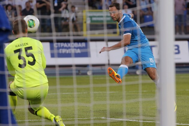 Zenit's Roman Shirokov, right, scores a goal past FC Nordsjaelland's goalkeeper Martin Hansen during the second leg of the third qualifying round of the UEFA Champions League, between Nordsjaelland and Zenit St. Petersburg in St.Petersburg, Russia, Wednesday, Aug. 7, 2013. (AP Photo/Dmitry Lovetsky)