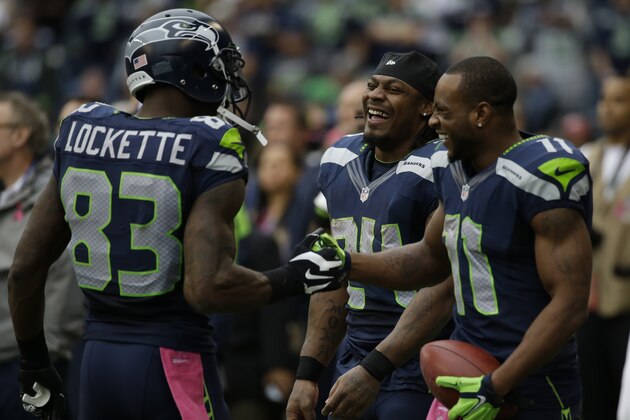 Seattle Seahawks' Ricardo Lockette, Marshawn Lynch, and Percy Harvin, stand on the sideline in the second half of an NFL football game against the Dallas Cowboys, Sunday, Oct. 12, 2014, in Seattle. (AP Photo/Elaine Thompson)