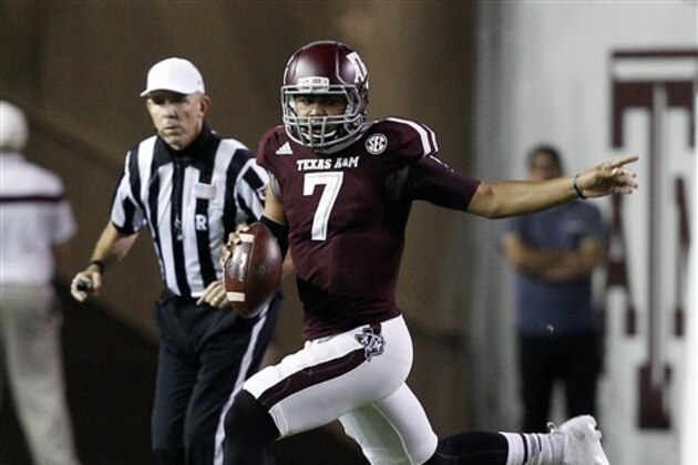 Texas A&M quarterback Kenny Hill scrambles out of the pocket during the second quarter of an NCAA college football game against Mississippi, Saturday, Oct. 11, 2014, in College Station, Texas. (AP Photo/Bob Levey)
