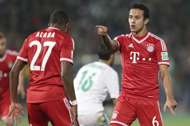 Bayern's Thiago Alcantara, right, celebrates scoring his side's 2nd goal with his teammate David Alaba during the final of the soccer Club World Cup  between FC Bayern Munich and Raja Casablanca in Marrakech, Morocco, Saturday, Dec. 21, 2013. (AP Photo/Matthias Schrader)