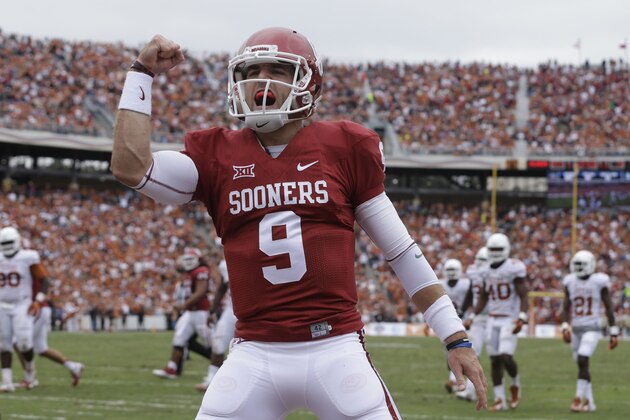 Oklahoma quarterback Trevor Knight (9) celebrates a touchdown by teammate Samaje Perine during the second half of an NCAA college football game against Texas at the Cotton Bowl, Saturday, Oct. 11, 2014, in Dallas. (AP Photo/LM Otero)