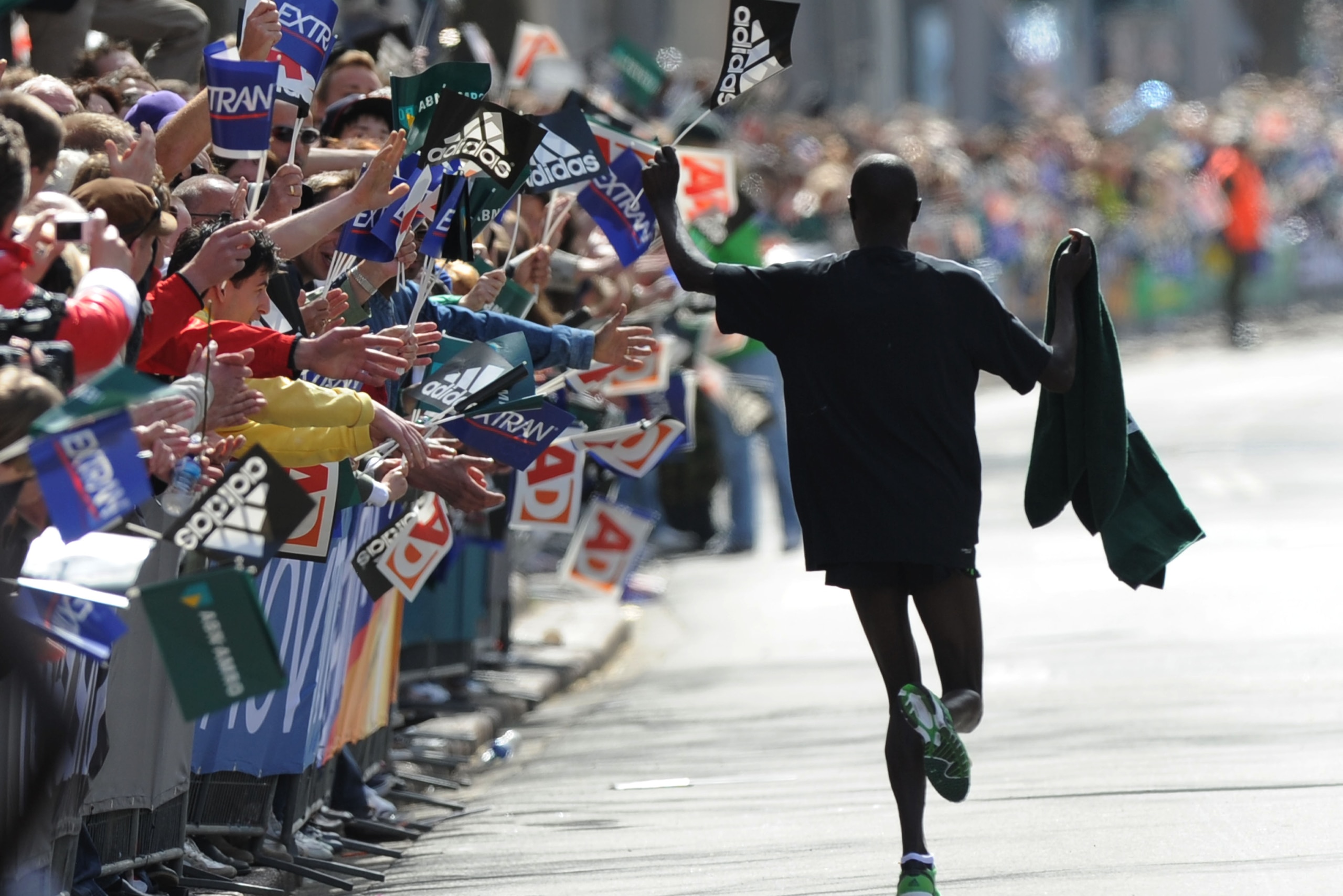 Wilson Chebet of Kenya reacts with the crowd after crossing the finish line to win the Rotterdam Marathon, in Rotterdam, Netherlands, Sunday April 10, 2011. (AP Photo/Ermindo Armino)