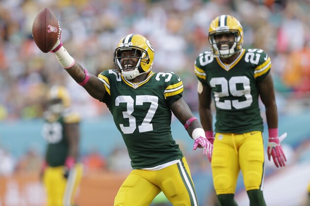 Green Bay Packers cornerback Sam Shields (37) holds the ball after intercepting a pass intended for Miami Dolphins wide receiver Brian Hartline (82) during the first half of an NFL football game, Sunday, Oct. 12, 2014, in Miami Gardens, Fla. In the background is Green Bay Packers cornerback Casey Hayward (29). AP Photo/Wilfredo Lee)
