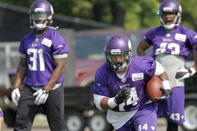 Minnesota Vikings running back Matt Asiata (44) carries the ball in front of running backs Jerick McKinnon (31) and Dominique Williams (43) during an NFL organized training activity in Eden Prairie, Minn., Wednesday, June 11, 2014. (AP Photo/Ann Heisenfelt)