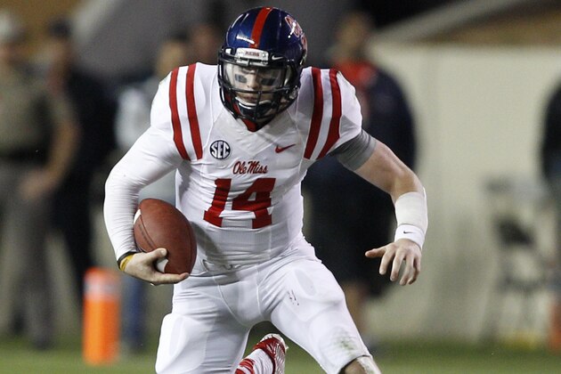 Mississippi quarterback Bo Wallace (14) looks for room as he scrambles out of the pocket against Texas A&M during the fourth quarter of an NCAA college football game Saturday, Oct. 11,  2014, in College Station, Texas. (AP Photo/Bob Levey)