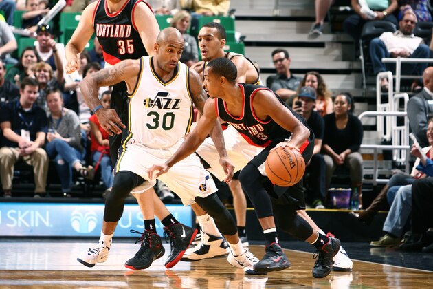 SALT LAKE CITY, UT - OCTOBER 07:  C.J. McCollum #3 of the Portland Trail Blazers drives against Dahntay Jones #30 of the Utah Jazz at EnergySolutions Arena on October 7, 2014 in Salt Lake City, Utah. NOTE TO USER: User expressly acknowledges and agrees that, by downloading and or using this Photograph, User is consenting to the terms and conditions of the Getty Images License Agreement. Mandatory Copyright Notice: Copyright 2014 NBAE (Photo by Melissa Majchrzak/NBAE via Getty Images)