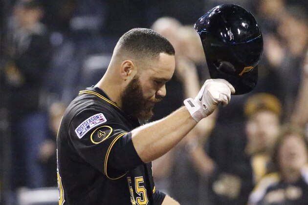 Pittsburgh Pirates catcher Russell Martin tips his helmet to the cheering fans after his last at-bat against the San Francisco Giants, in the ninth inning of the NL wild-card playoff baseball game Wednesday, Oct. 1, 2014, in Pittsburgh. The Giants won 8-0, advancing to the division series. (AP Photo/Gene J. Puskar)