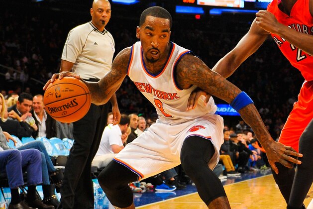 NEW YORK, NY - OCTOBER 13: J.R. Smith #8 of the New York Knicks controls the ball against Jordan Hamilton #25 of the Toronto Raptors in the second half at Madison Square Garden on October 13, 2014 in New York City. NOTE TO USER: User expressly acknowledges and agrees that, by downloading and/or using this photograph, user is consenting to the terms and conditions of the Getty Images License Agreement. (Photo by Alex Goodlett/Getty Images)