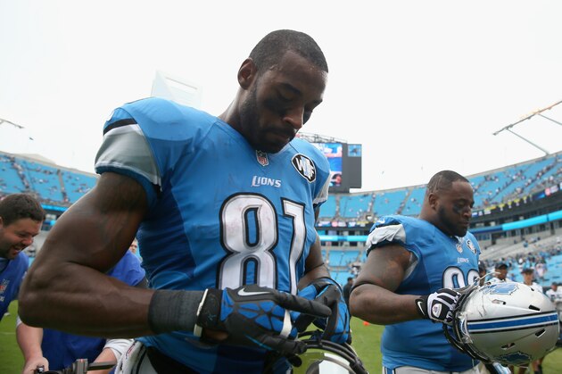 CHARLOTTE, NC - SEPTEMBER 14:   Calvin Johnson #81 and teammate  C.J. Mosley #99 of the Detroit Lions walk off the field after losing to the Carolina Panthers 24-7 during the game at Bank of America Stadium on September 14, 2014 in Charlotte, North Carolina.  (Photo by Streeter Lecka/Getty Images)