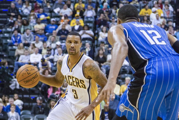 Oct 10, 2014; Indianapolis, IN, USA;  Indiana Pacers guard George Hill (3) dribbles the ball in on Orlando Magic forward Tobias Harris (12) in the third quarter at Bankers Life Fieldhouse. The Orlando Magic beat the Indiana Pacers by the score of  96-93. Mandatory Credit: Trevor Ruszkowski-USA TODAY Sports