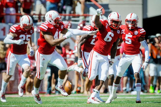 LINCOLN, NE - SEPTEMPER 6: Safety Corey Cooper #6 of the Nebraska Cornhuskers celebrates with teammates during their game at against the McNeese State CowboysMemorial Stadium on September 6, 2014 in Lincoln, Nebraska. Nebraska defeated McNeese State 31-24. (Photo by Eric Francis/Getty Images)