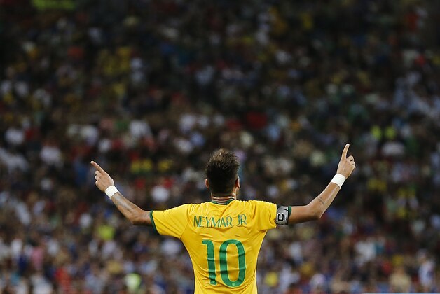 Brazil's Neymar celebrates after scoring the forth goal during an international friendly soccer match in Singapore, Tuesday, Oct. 14, 2014. (AP Photo/Wong Maye-E)