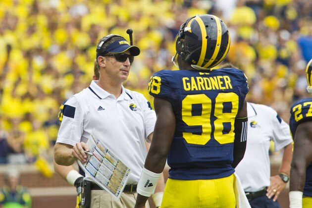 Michigan offensive coordinator Doug Nussmeier, left, gives coaching to quarterback Devin Gardner (98) in the third quarter of an NCAA college football game against Appalachian State in Ann Arbor, Mich., Saturday, Aug. 30, 2014. Michigan won 52-14. (AP Photo/Tony Ding)
