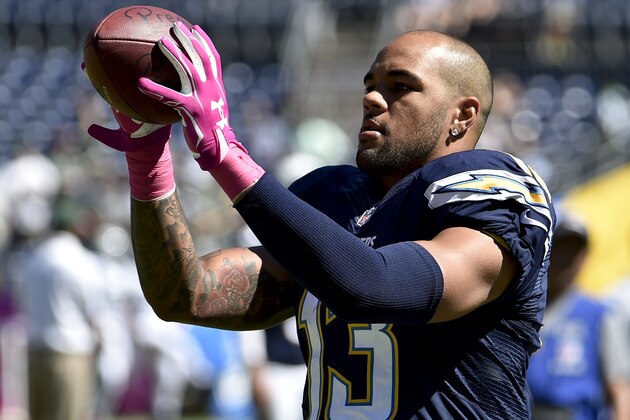 San Diego Chargers wide receiver Keenan Allen warns up wearing pink gloves in honor of Breast Cancer Awareness before an NFL football game against the New York Jets, Sunday, Oct. 5, 2014, in San Diego. (AP Photo/Denis Poroy)