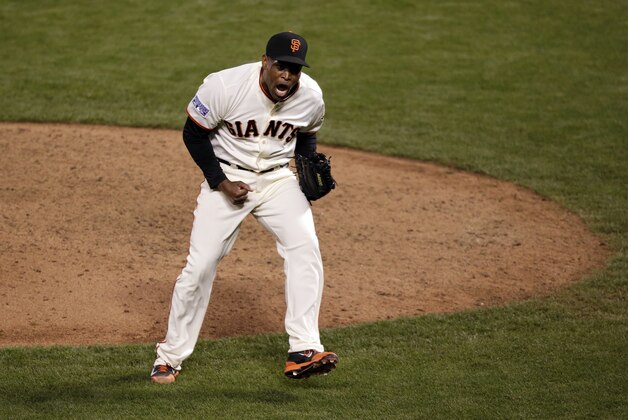 San Francisco Giants relief pitcher Santiago Casilla celebrates at the end of the game against the St. Louis Cardinals during the Game 4 of the National League baseball championship series Wednesday, Oct. 15, 2014, in San Francisco. The Giants won 6-4 to lead the series 3-1. (AP Photo/Marcio Jose Sanchez)