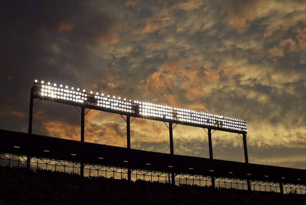 The sun sets behind Oriole Park at Camden Yards during an interleague baseball game between the Baltimore Orioles and the Washington Nationals, Wednesday, July 9, 2014, in Baltimore. (AP Photo/Patrick Semansky)
