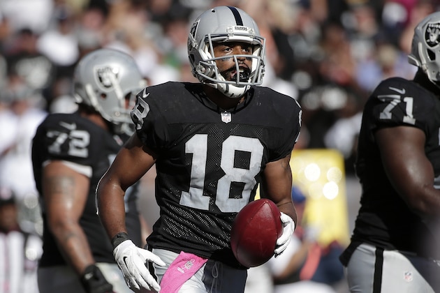 Oakland Raiders wide receiver Andre Holmes (18) runs to the sideline after catching a 6-yard touchdown pass during the fourth quarter of an NFL football game against the San Diego Chargers in Oakland, Calif., Sunday, Oct. 12, 2014. (AP Photo/Marcio Jose Sanchez)
