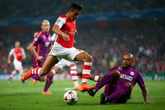 LONDON, ENGLAND - OCTOBER 01:  Alexis Sanchez of Arsenal battles for the ball with Felipe Melo of Galatasaray AS during the UEFA Champions League group D match between Arsenal FC and Galatasaray AS at Emirates Stadium on October 1, 2014 in London, United Kingdom.  (Photo by Paul Gilham/Getty Images)