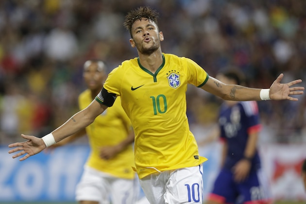 Brazil's Neymar celebrates  after scoring his fourth goal against Japan during an international friendly soccer match in Singapore, Tuesday, Oct. 14, 2014. (AP Photo/Wong Maye-E)