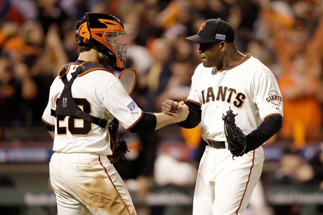 SAN FRANCISCO, CA - OCTOBER 15:  Santiago Casilla #46 and Buster Posey #28 of the San Francisco Giants celebrate after getting the final out in the ninth inning against the St. Louis Cardinals during Game Four of the National League Championship Series at AT&T Park on October 15, 2014 in San Francisco, California.  (Photo by Ezra Shaw/Getty Images)