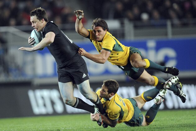 New Zealand’s Ben Smith is tackled by Australia’s Bernard Foley, and Nick Phipps, up, during the International test Bledisloe Cup rugby match at Eden Park in Auckland, New Zealand, Saturday, Aug. 23 2014. (AP Photo/SNPA, Ross Setford)  NEW ZEALAND OUT