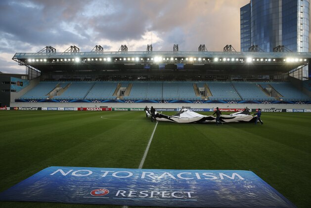 Stewards rehearse the opening ceremony in a stadium devoid of fans prior to the Group E Champions League match between CSKA Moscow and Bayern Munich at Arena Khimki stadium in Moscow, Russia, Tuesday Sept. 30, 2014. CSKA were sanctioned by governing body UEFA to play in an empty stadium after the behaviour of their fans during group stage matches against Manchester City and Czech club Viktoria Plzen last season. (AP Photo/Pavel Golovkin)